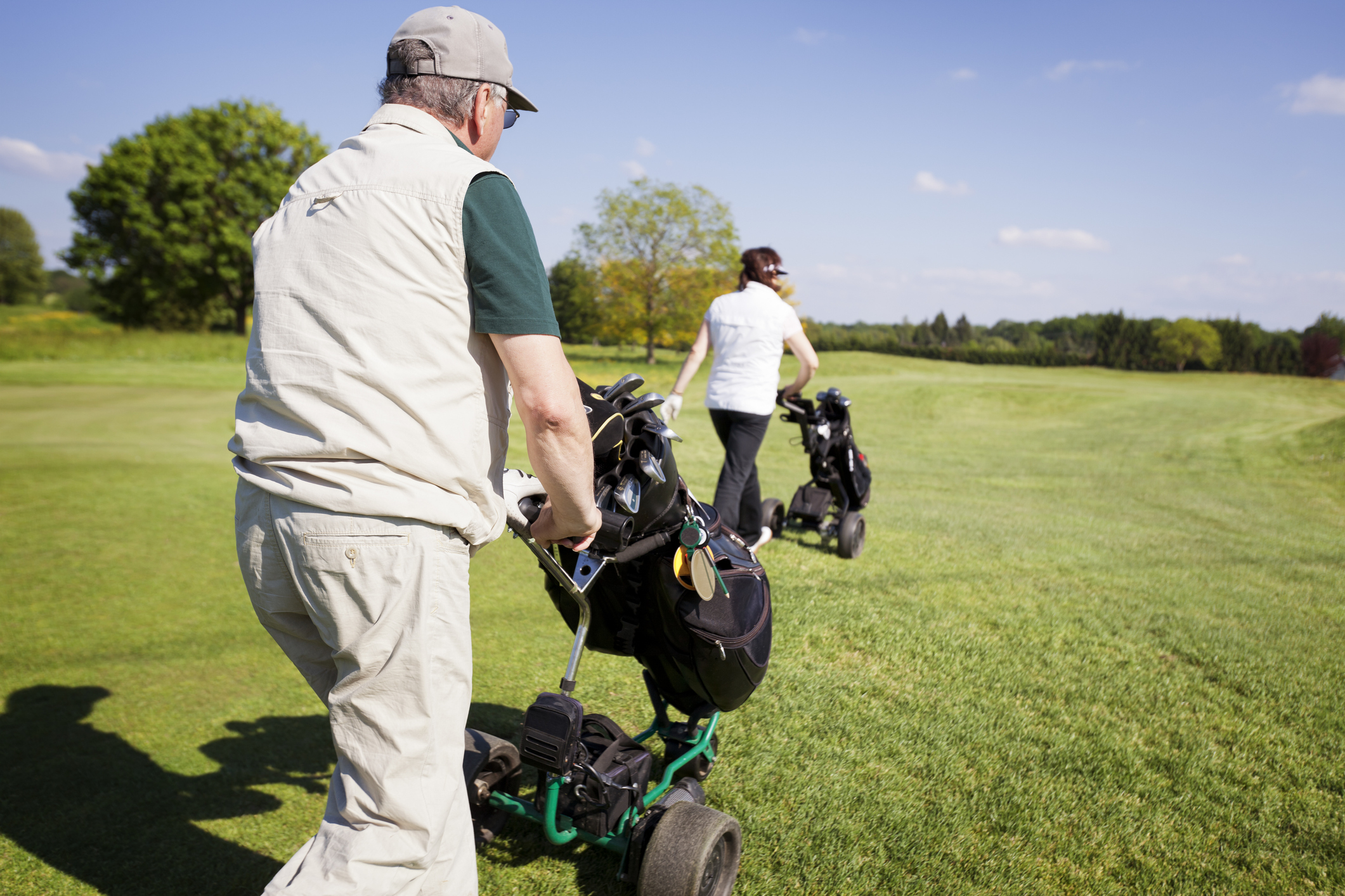 Mann schiebt Golftrolley